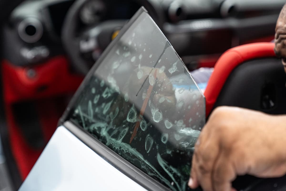 Car window tint film being installed on door glass