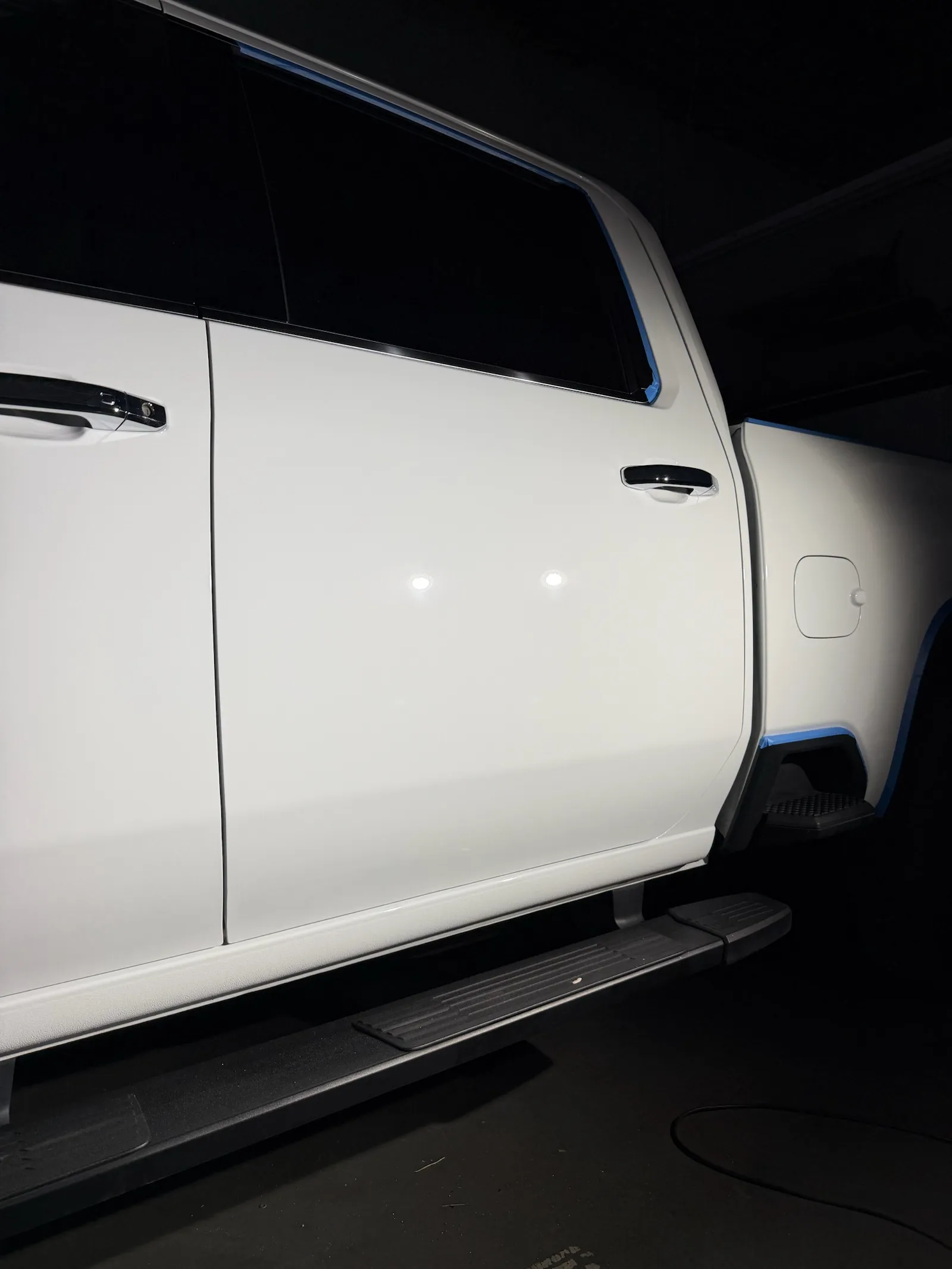 After: side of a white Chevy Silverado 3500HD in the bay