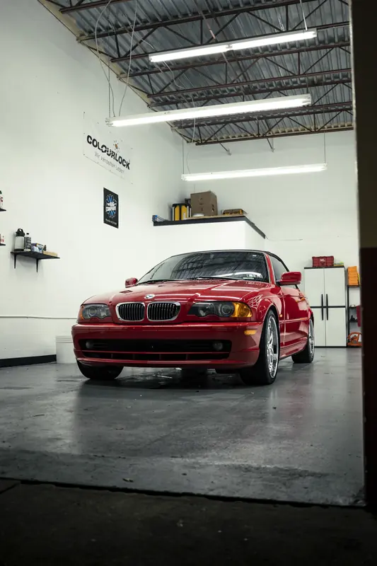 Red BMW 330Ci convertible in the 355 Auto Spa bay