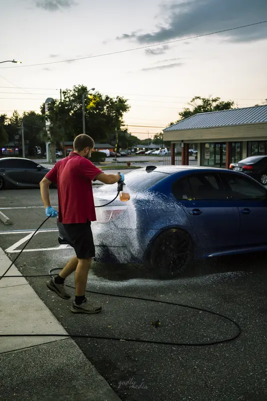 BMW M5 covered in foam during a hand wash