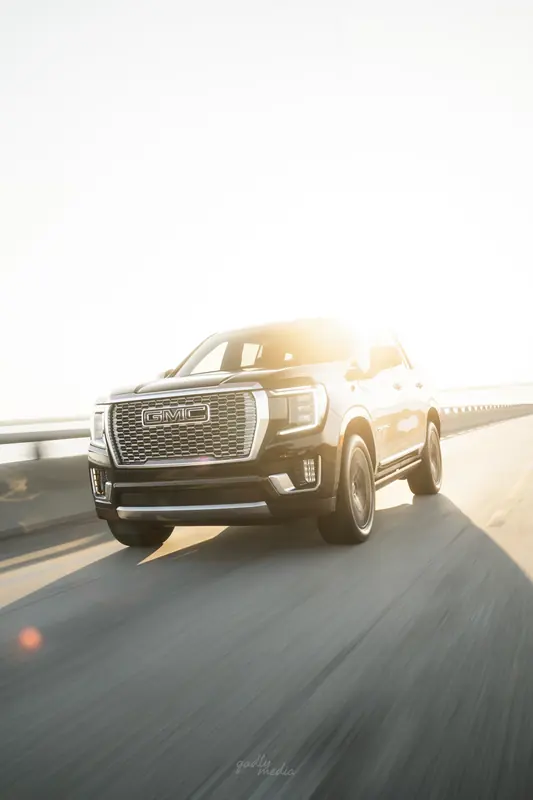 Black GMC Yukon Denali front with sun flare