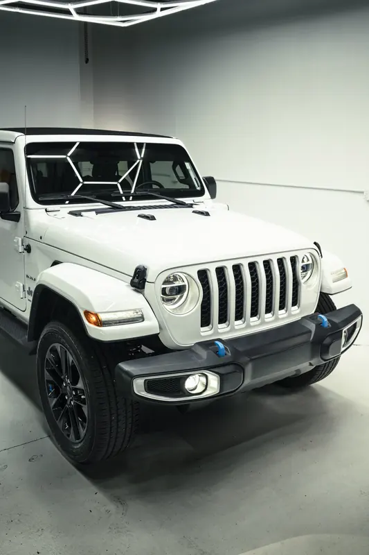 Detailed white Jeep Wrangler 4xe, low front three-quarter