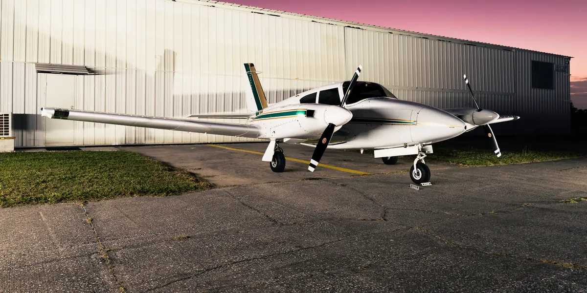Piper Twin Comanche on the ramp at sunset after detailing