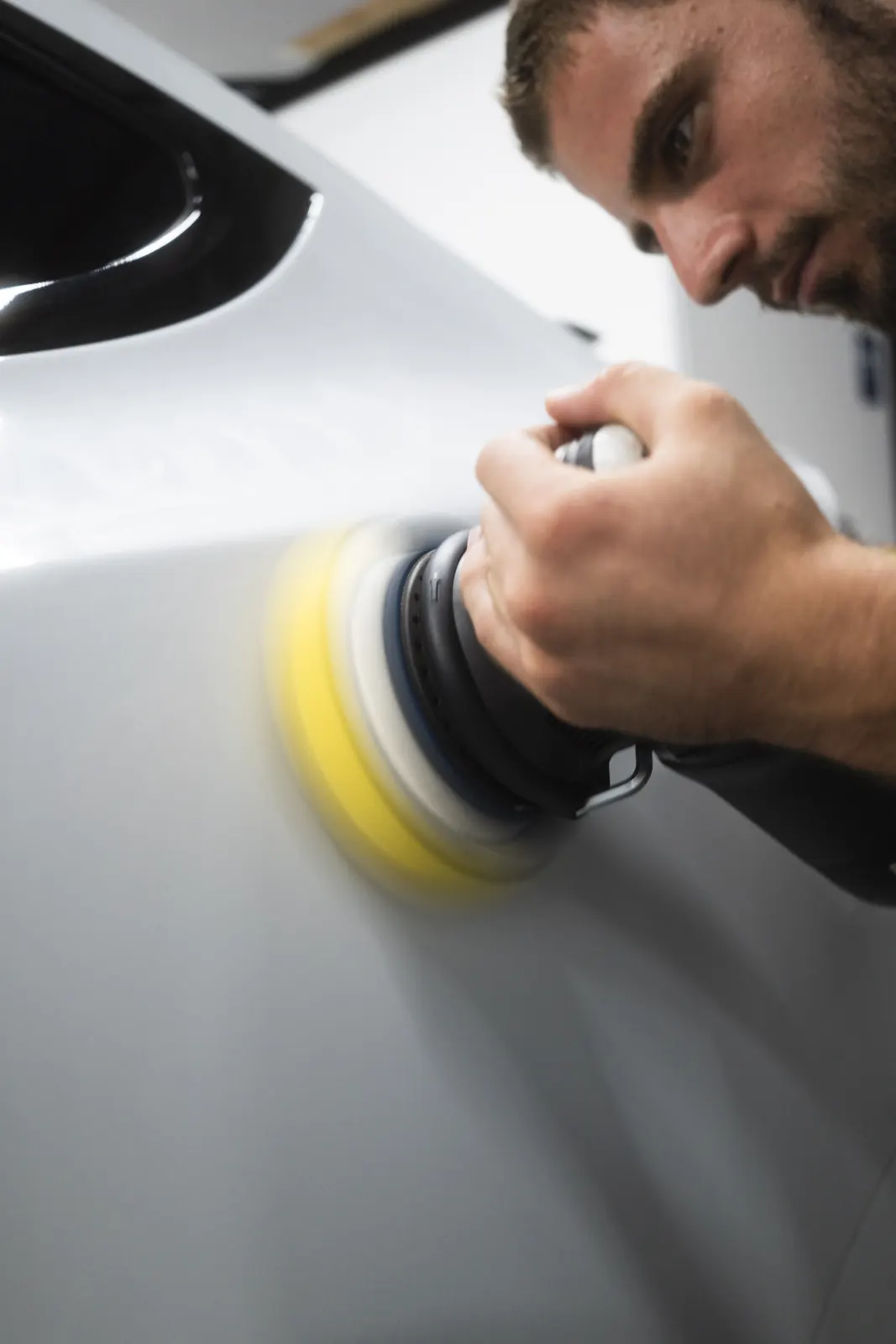 RUPES dual-action polisher on a Tesla Model X panel
